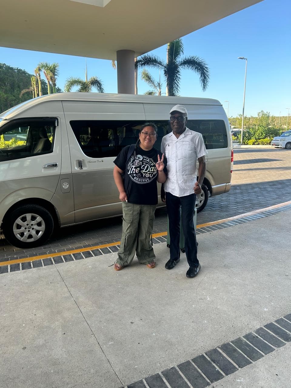Guest with Mr. Bailey beside the van after an airport transfer