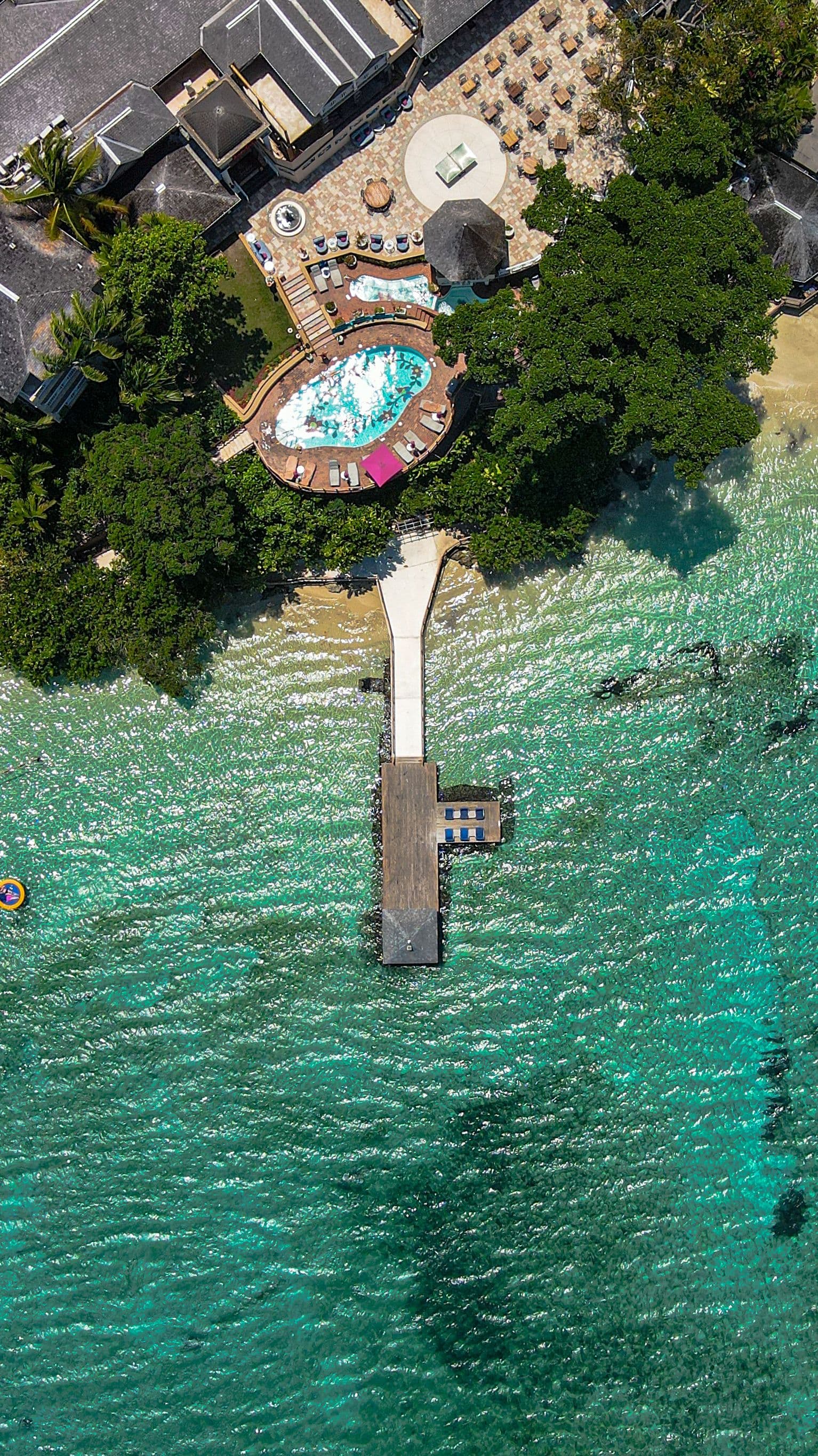 Aerial view of a resort beach and pier in Ocho Rios