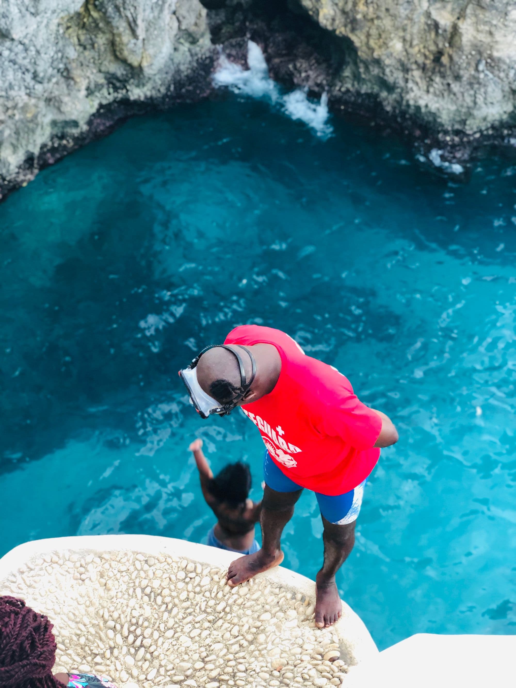 Cliff diver about to leap into the sea at Negril